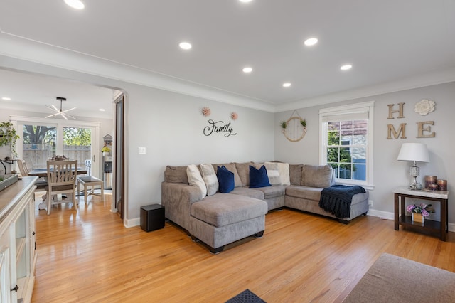 living room with plenty of natural light, light wood-style flooring, and recessed lighting