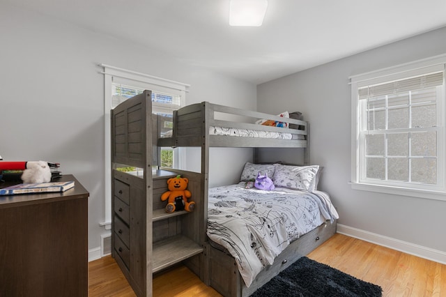 bedroom with wood finished floors and baseboards