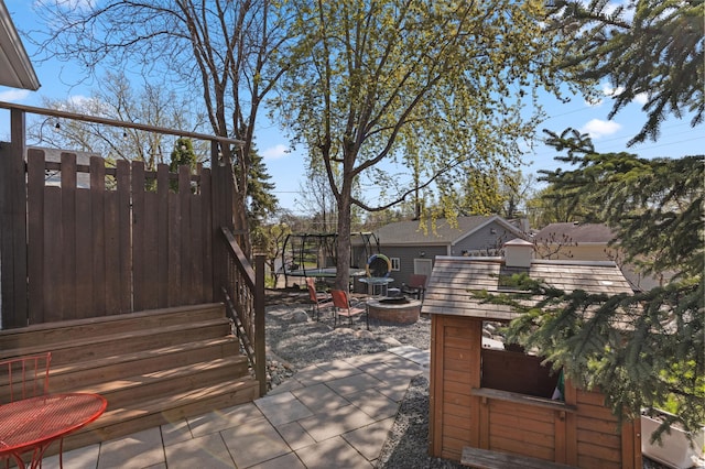 view of patio / terrace with a fire pit and fence
