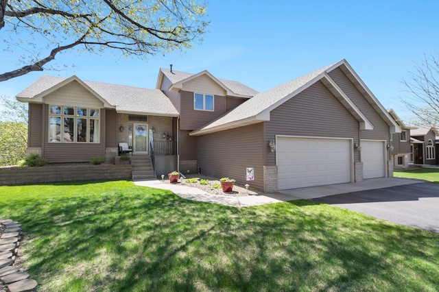 1282 141st Ln NW, Andover, MN 55304 - tri-level home featuring a garage, asphalt driveway, a front lawn, and a shingled roof
