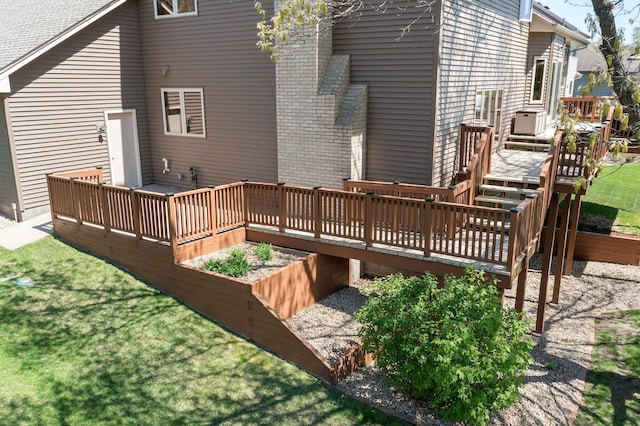 1282 141st Ln NW, Andover, MN 55304 - back of house with a deck, a garden, and a lawn