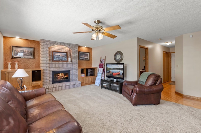 1282 141st Ln NW, Andover, MN 55304 - living room featuring carpet, ceiling fan, a fireplace, and a textured ceiling
