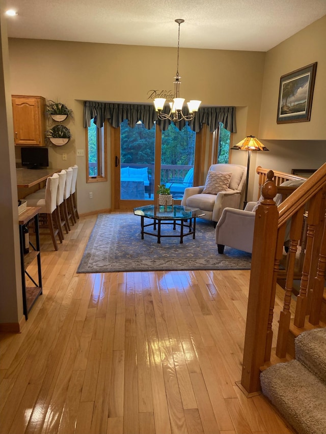 1282 141st Ln NW, Andover, MN 55304 - dining space with stairs, a chandelier, and light wood-style flooring