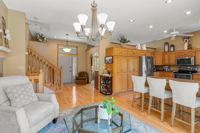 1282 141st Ln NW, Andover, MN 55304 - living room with recessed lighting, stairway, light wood-style floors, a ceiling fan, and lofted ceiling