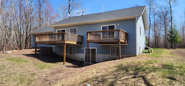 rear view of house with a deck and a shingled roof