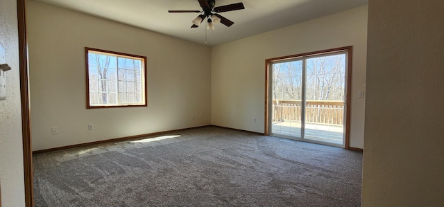 carpeted empty room featuring ceiling fan, baseboards, and a healthy amount of sunlight