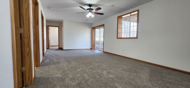 carpeted spare room with baseboards and ceiling fan