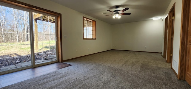 carpeted empty room with visible vents, baseboards, and a ceiling fan
