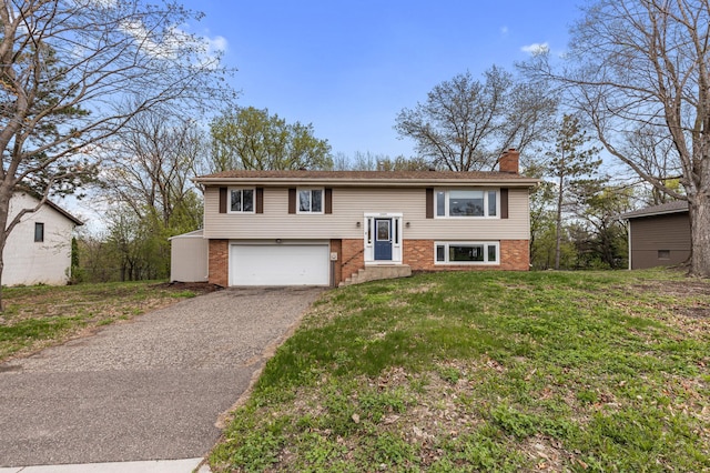 2409 Highland View Ave S, Burnsville, MN 55337 - raised ranch featuring brick siding, a chimney, a garage, driveway, and a front yard