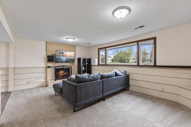 2409 Highland View Ave S, Burnsville, MN 55337 - living room with a textured ceiling, a fireplace, and carpet floors