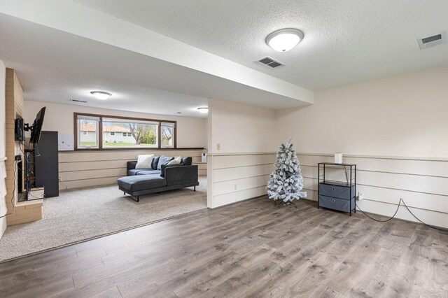 2409 Highland View Ave S, Burnsville, MN 55337 - sitting room featuring wood finished floors, a textured ceiling, and wainscoting