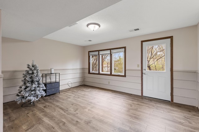 2409 Highland View Ave S, Burnsville, MN 55337 - entryway with wainscoting, wood finished floors, and a textured ceiling
