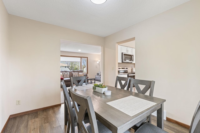 2409 Highland View Ave S, Burnsville, MN 55337 - dining space with wood finished floors, baseboards, and a textured ceiling