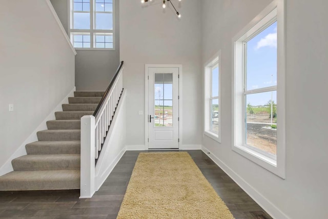 10833 38th Trl N, Lake Elmo, MN 55042 - foyer with healthy amount of natural light, stairs, dark wood-type flooring, a towering ceiling, and baseboards