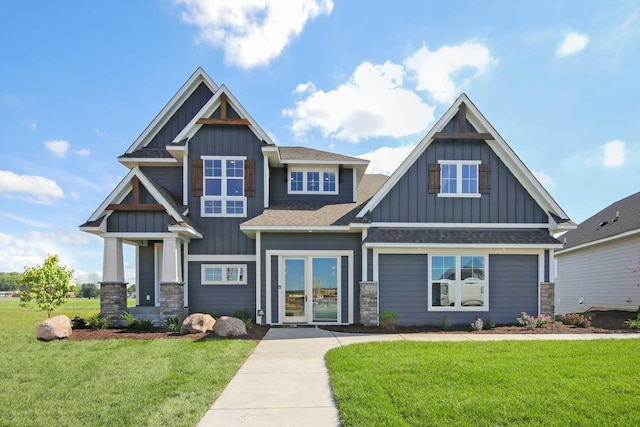 10833 38th Trl N, Lake Elmo, MN 55042 - craftsman-style home featuring board and batten siding, a front yard, roof with shingles, and stone siding