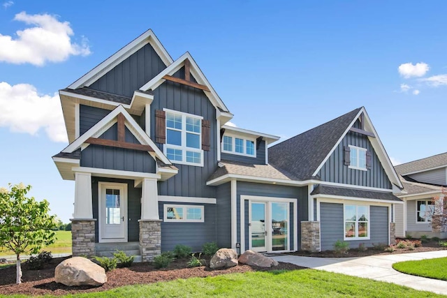 10833 38th Trl N, Lake Elmo, MN 55042 - craftsman inspired home featuring board and batten siding, roof with shingles, french doors, and stone siding