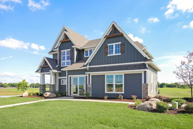 10833 38th Trl N, Lake Elmo, MN 55042 - craftsman-style house with board and batten siding, roof with shingles, a front yard, and stone siding