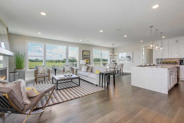 10833 38th Trl N, Lake Elmo, MN 55042 - living room featuring a chandelier, recessed lighting, dark wood-type flooring, and a fireplace