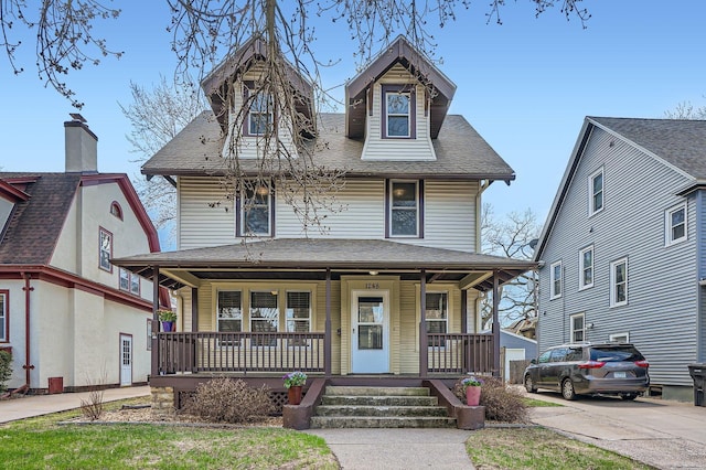 view of front of house with roof with shingles and covered porch