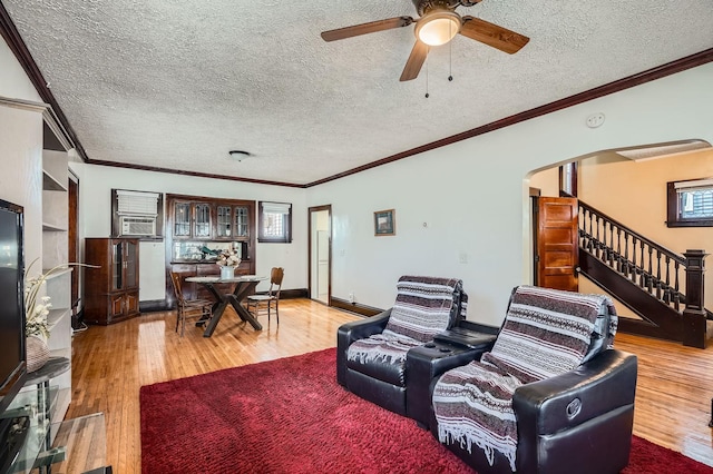 living room featuring ornamental molding and wood finished floors