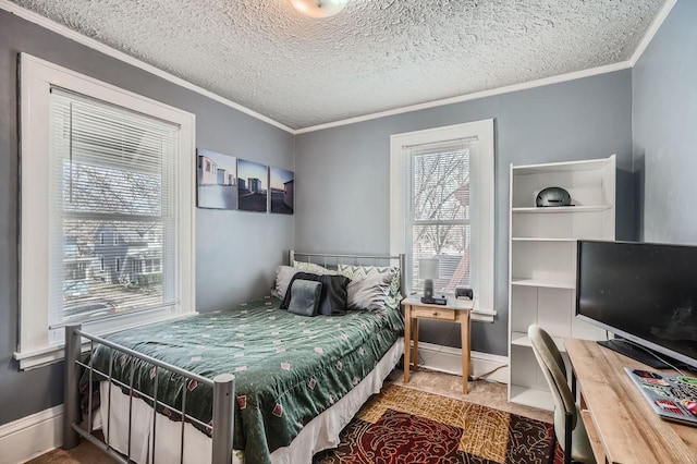 bedroom featuring crown molding, a textured ceiling, and baseboards