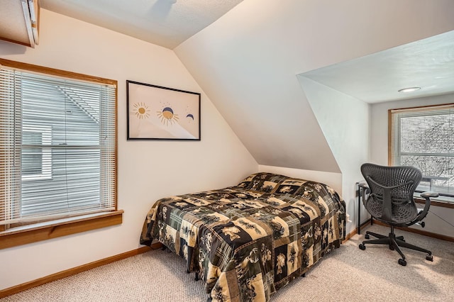 bedroom featuring baseboards, carpet flooring, and lofted ceiling