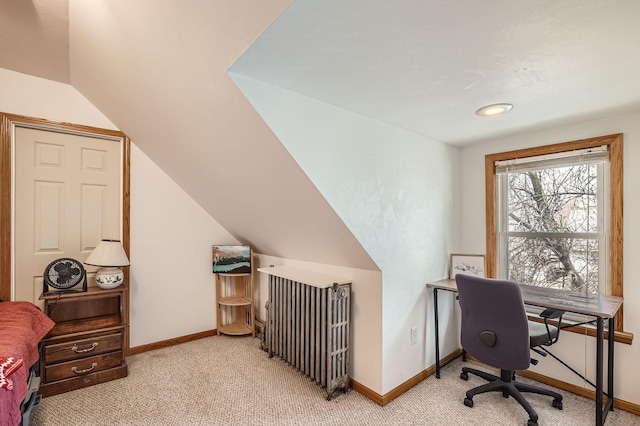 office space with lofted ceiling, baseboards, and light colored carpet