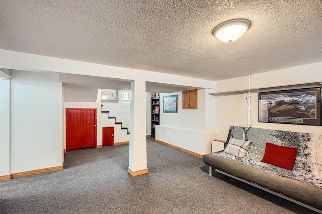 finished basement featuring carpet, a textured ceiling, stairway, and baseboards