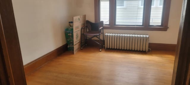 3229 Chicago Ave, Minneapolis, MN 55407 - sitting room with radiator heating unit, wood finished floors, and baseboards