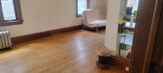 3229 Chicago Ave, Minneapolis, MN 55407 - bedroom featuring wood finished floors, radiator, and baseboards