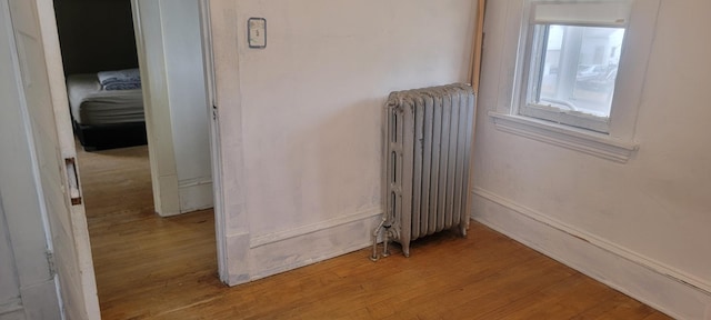 3229 Chicago Ave, Minneapolis, MN 55407 - detailed view of radiator, wood finished floors, and baseboards