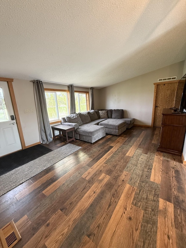 living room featuring wood-type flooring and a textured ceiling