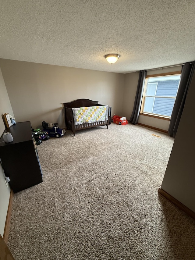 bedroom featuring carpet floors and a textured ceiling