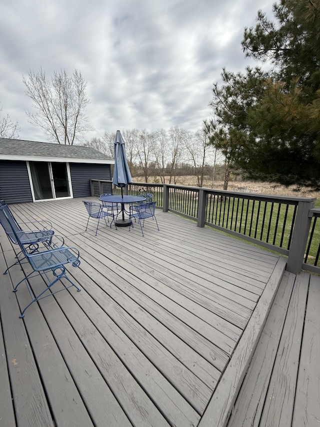 wooden terrace featuring outdoor dining area