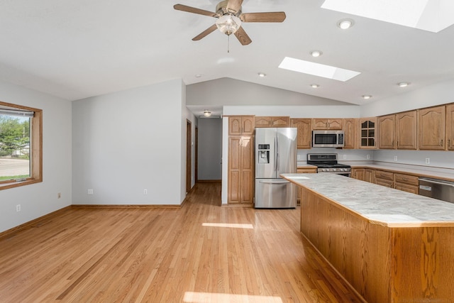 4416 Louisiana Ave N, Crystal, MN 55428 - kitchen featuring stainless steel appliances, a skylight, light countertops, lofted ceiling, and glass insert cabinets