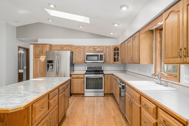 4416 Louisiana Ave N, Crystal, MN 55428 - kitchen featuring stainless steel appliances, a sink, vaulted ceiling, light countertops, and a skylight