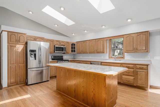 4416 Louisiana Ave N, Crystal, MN 55428 - kitchen with appliances with stainless steel finishes, a skylight, a sink, light countertops, and vaulted ceiling