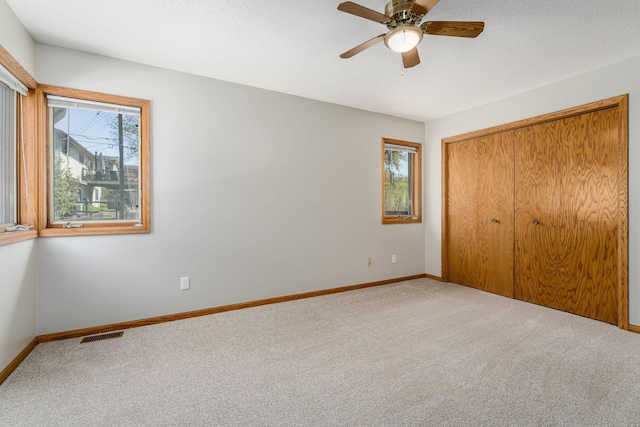 4416 Louisiana Ave N, Crystal, MN 55428 - unfurnished bedroom with multiple windows, carpet floors, and baseboards