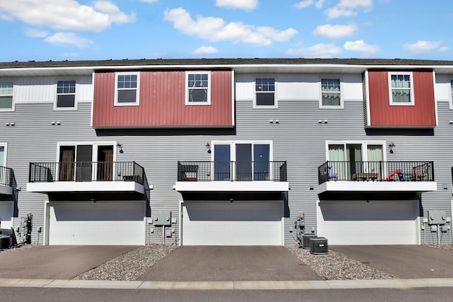10240 3rd St NE Unit D, Blaine, MN 55434 - view of front facade with an attached garage, central AC, and asphalt driveway