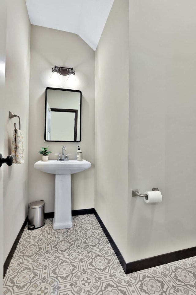 10240 3rd St NE Unit D, Blaine, MN 55434 - bathroom with baseboards and vaulted ceiling
