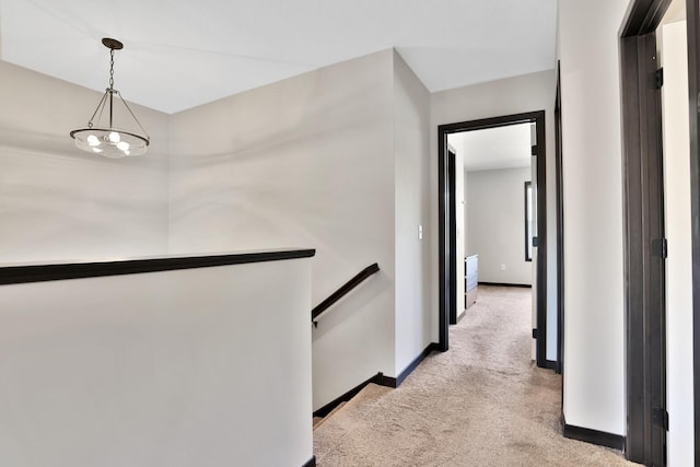 10240 3rd St NE Unit D, Blaine, MN 55434 - corridor featuring an upstairs landing, light colored carpet, and baseboards