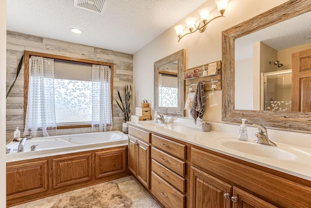 1103 Park Ln SE, New Prague, MN 56071 - full bath with plenty of natural light, a textured ceiling, double vanity, a garden tub, and an enclosed shower