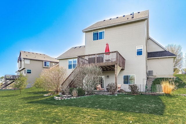 1103 Park Ln SE, New Prague, MN 56071 - rear view of house featuring a lawn, roof with shingles, and a wooden deck