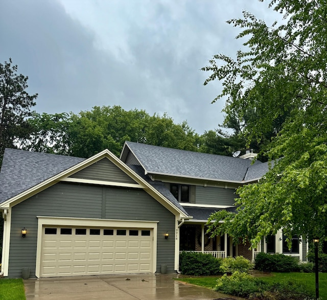 7718 74th St S, Cottage Grove, MN 55016 - view of front of house with a shingled roof, concrete driveway, a garage, and a porch