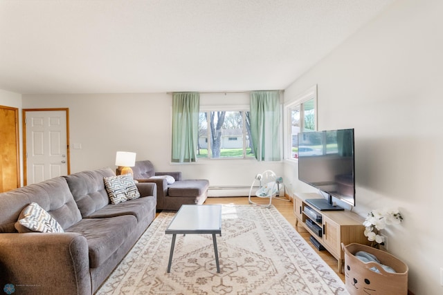 living room with baseboard heating and wood finished floors