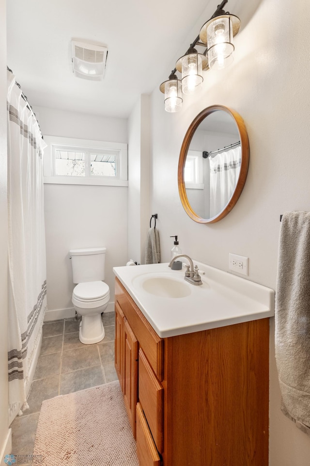 full bath with vanity, toilet, and baseboards