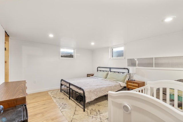 bedroom featuring wood finished floors, recessed lighting, and baseboards