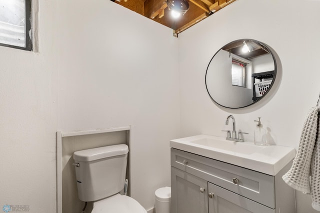half bathroom with toilet and vanity