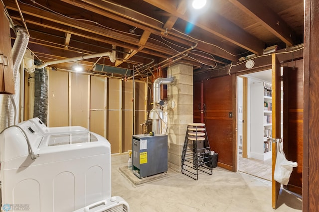 unfinished basement with washer and clothes dryer and a heating unit