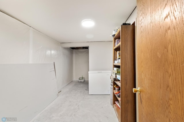 finished below grade area featuring refrigerator